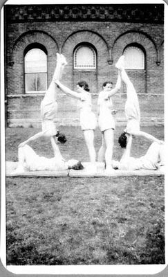 Marg Helson and friends demonstrate gymnastic routines in front of  Georgetown High School, 70 Guelph Street.