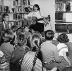 Georgetown Public Library - Librarian Anne Anderson entertaining children by singing and playing guitar.