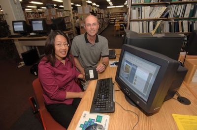 Manager of Public Services Geoff Cannon presented an iPod to  Sandra Wui at the Georgetown branch of Halton Hills Public Library.