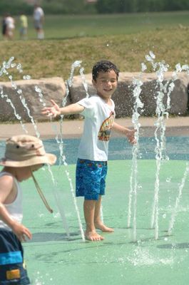 A boy enjoys the spray at the Gellert Centre splash pad.