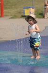 Ethan Bailey, aged two-years -old cautiously tests the splash pad at  the Gellert Centre.