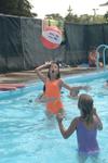 Two girls toss a beach ball between them at the Acton Wading Pool in  Prospect Park.