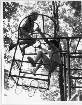 Two children enjoy new playground equipment at  Fairgrounds Park.