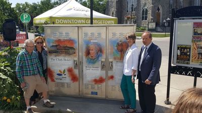 The utility box cover - features The Clark Hotel, Sandy Mackenzie, and the Memorial Tree.