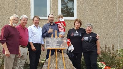 Gathering around a plaque honouring Canadian singer 'Stompin' Tom Connors.