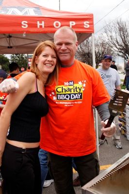 Mike Holmes and Michelle Stafford hug at M&M Meat fundraiser.