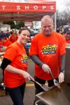 Mike Holmes and volunteer at M&M Meat Shop BBQ fundraiser.