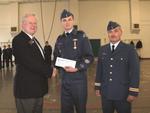 Warrant Officer Christopher Bechard accepts congratulations and cheque after winning a province-wide draw.