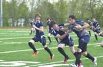 Nick Cunha takes on Callaghan Murphy and Cory Carpenter during Halton High School junior rugby match.