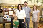Arianne LeRouzers shows family school work at McKenzie-Smith Bennett family education night.
