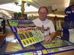 Fred Harris displays lottery scratch and win tickets