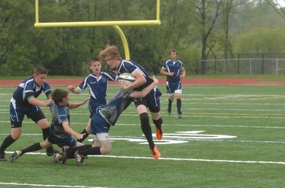 Rebel Cory Carpenter brought down by Nick Tibbits and Andrew Punsack during Halton junior Rugby semifinal