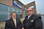 Ipro Realty co-founder Rui Alves celebrates with Fedele Colucci at the Georgetown office's grand opening