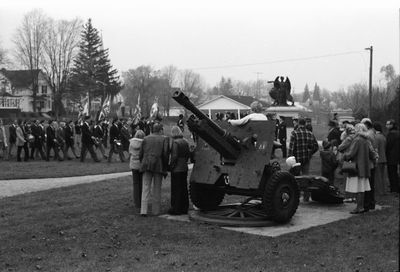 Citizens gather around air craft carrier to watch the Remembrance Day parade