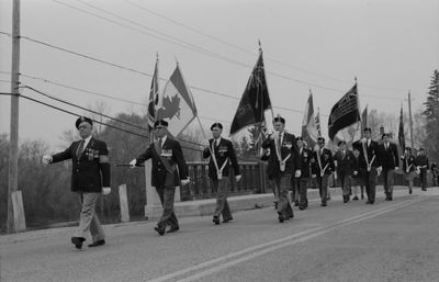 The Legion Colour Party marches over the Credit River bridge.