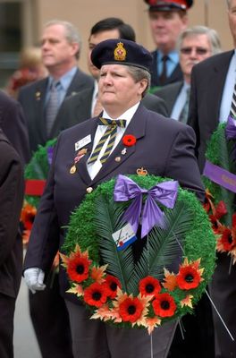 Peggy Harris holds a wreath at Remembrance Ceremony