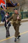 A man dressed as a WWI solder marches in the Remembrance Day Parade.