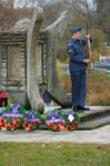 A Georgetown Air Cadet presents arms during the Remembrance Service