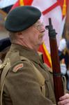A man dressed as a World War I veteran presents arms during the Remembrance Service