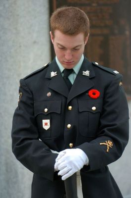 A man dressed as a World War I veteran presents arms during the Remembrance Service