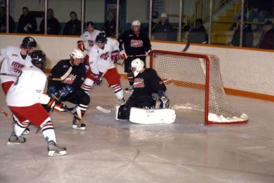 A scramble for the puck in front of the net in a Future Stars game at Mold-Masters SportsPlex