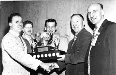 Jaycee President Wally Scinski (L) hands trophy to Walter &quot;Red&quot; Asseltine