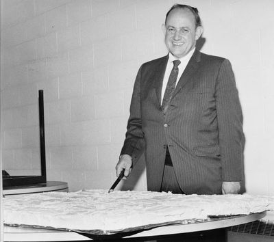 H.C. Williamson cuts cake at General Fireproofing 2nd anniversary