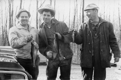 Albert Enman and Will Ramsay show their catch to Allan Burke