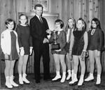 Young figure skaters receive their awards from Tom Pettingill