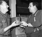 Corporal George Crooks receives birthday cupcake from Jim Brandon while in northern Norway.