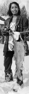 Visitor from Trinidad catches trout while ice fishing