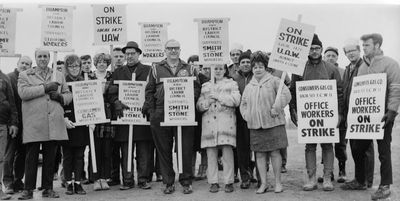 Strikers with picket signs in front of Smith & Stone Ltd. offices - strike continues