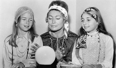 Melanie Harris, Mrs. Vera Macdonald, and Melitta Gasner  gazing into a crystal ball at Joseph Gibbons School’s Fun Day