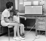 A teacher and student try out an electric screen