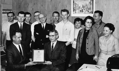 Jim Snow, MPP presents editor Walter Biehn with a plaque  recognizing the centennial of the Georgetown Herald.