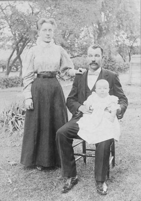 Man, woman, & child in garden