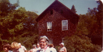 Pearl Shoebottom in front of an old home