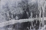 Three Men Standing on a Dam.