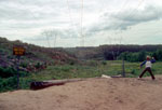 Before transfer station, trash thrown over hill