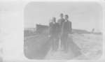 Men standing on culvert