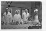 Kitchen staff standing by a banquet table at a special occasion