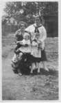 Unidentified women, three children and a puppy