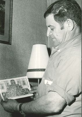 Haig Kouyoumjian shows a photograph of the Georgetown Boys to the Georgetown Herald, 1969.