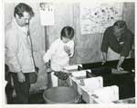 Three people in fish hatchery, Thessalon Township, Circa 1995