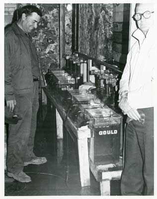 Two men with fish hatchery equipment, Thessalon Township, Circa 1995