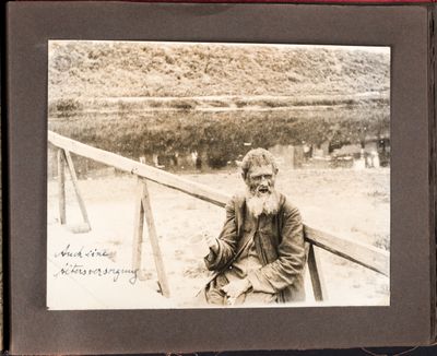 Elderly man sits on a bridge in Kharkiv, begging