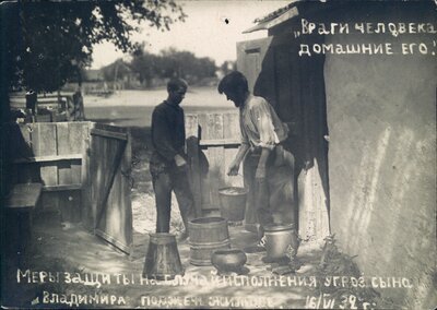 Nikolai Bokan and his son prepare buckets of water outside of their family home in anticipation of an arson attack.