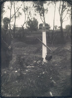 Nikolai Bokan stands beside the grave of his son Konstantin, who died of starvation.