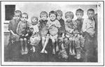 Non-Holodomor: Several children in Ukraine seated in a row, showing evidence of starvation
