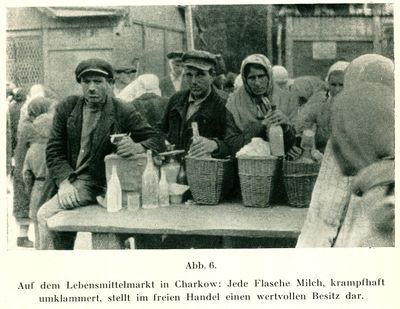 Several people at an open air food market in Kharkiv selling milk